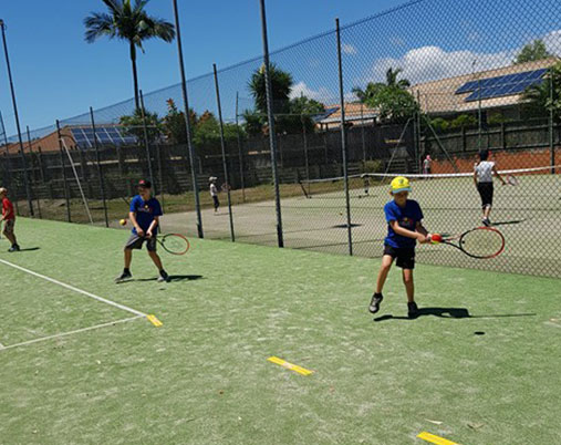 Playing tennis at our fun holiday camp